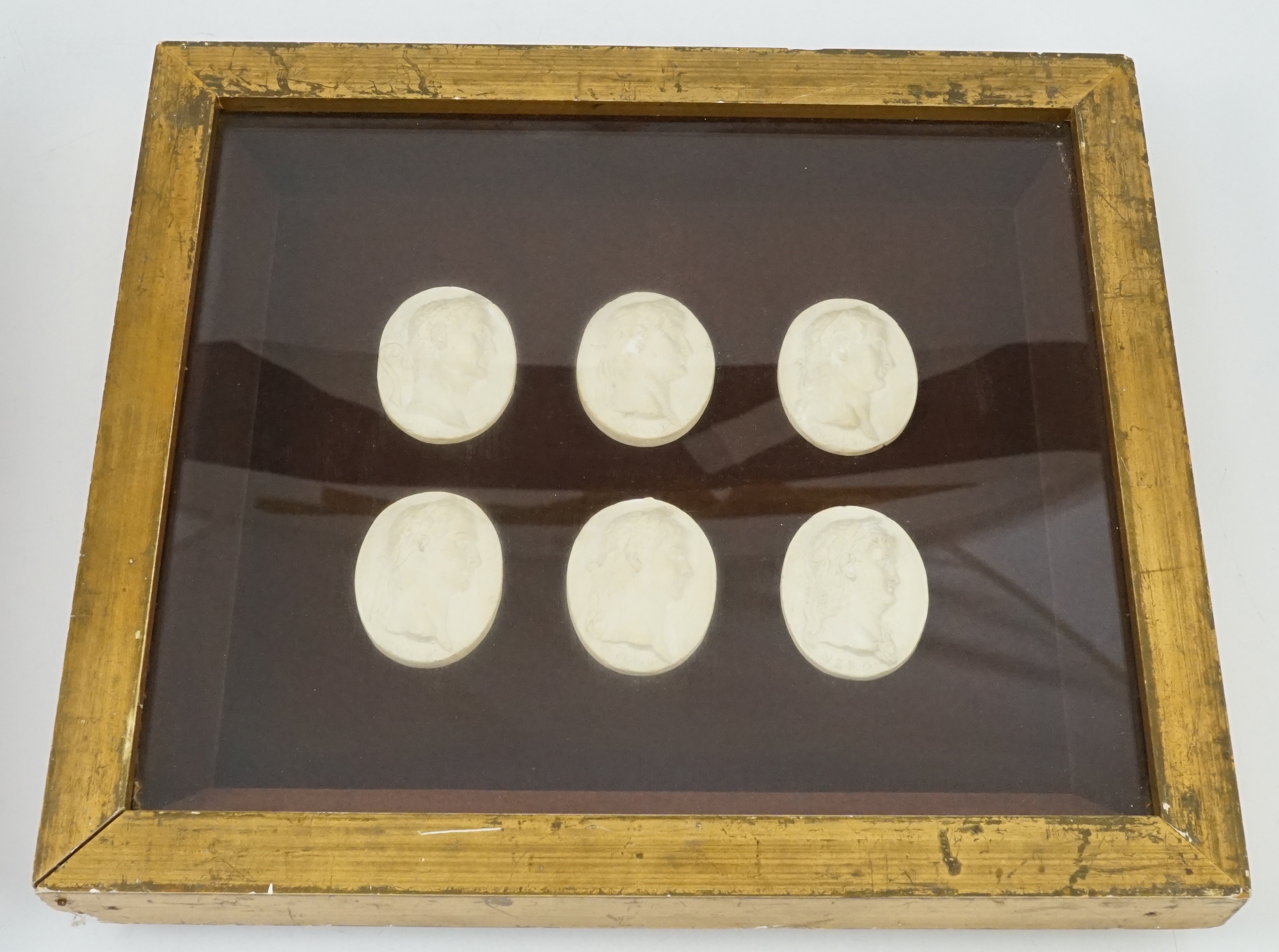 Three framed sets of simulated plaster classical gems, largest overall 30 x 30cm